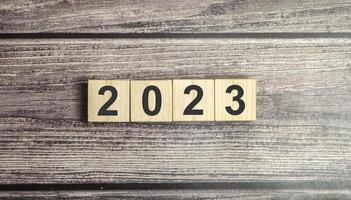 2023 Happy New Year wooden block number digit on wooden table photo