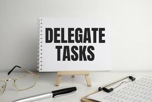 pen and a notepad with the inscription - Delegate Tasks photo