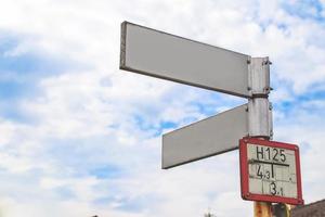 Blank directional road signs White against blue sky. photo