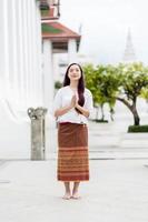 Portrait asia woman wearing traditional dress of Thailand praying in church photo