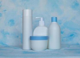 Bottles for cosmetic products without a label. Facial skin care concept. Texture background photo