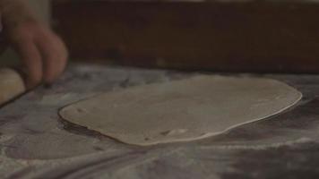 Close up hands working on bread dough in slow motion video