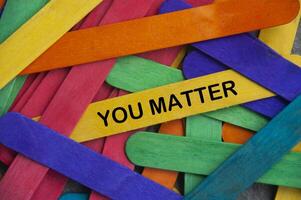 You matter text on yellow wooden stick - Inspirational concept photo