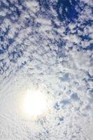 Blue sky with chemical clouds chemtrails on sunny day Germany. photo