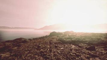 Atmospheric landscape with mountain lake among moraines in rainy weather video