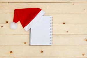 Santa hat and diary  on wooden table photo