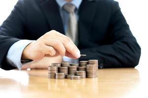 Hand putting stack of coins photo