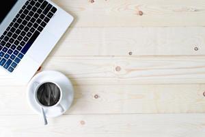 Keyboard of an open notebook, cup of coffee photo