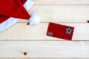 Retro toned Santa Claus hat on wooden desk photo