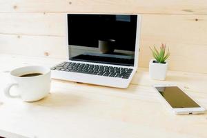 A table with blank laptop, tablet and smartphone photo