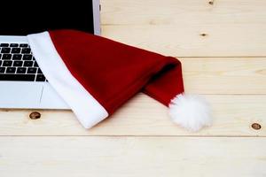 laptop with blank screen and Santa Slaus hat photo