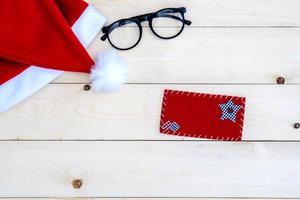 Retro toned Santa Claus hat on wooden desk photo