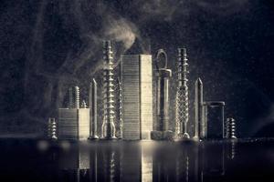 Abstract panorama of city illuminated by bright light with reflection, made by metal bolt, staples for paper stapler and nut chrome. Black background with bokeh and smoke . photo