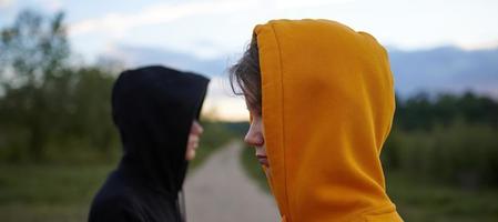 Two teenagers outdoors. Youth fashion. The concept of a quarrel. Problems of transitional age. photo