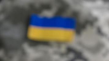 Blurred Ukraine flag on military uniform photo