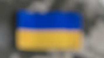 Blurred Ukraine flag on military uniform photo