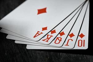 Royal flush on a black background. Playing card. The concept of victory. photo