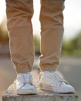 Feet man standing on concrete block. The concept of urban style. photo