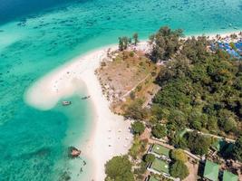 Karma white beach in emerald tropical sea at lipe island photo