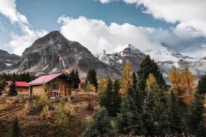 cabañas de madera con montañas rocosas en el bosque de otoño en el parque provincial de assiniboine foto