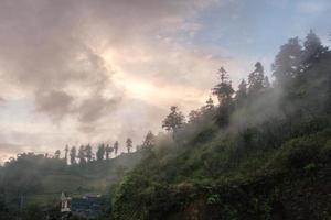 Foggy hill with colorful sky in countryside photo