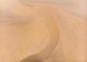 Stripe brown sand dunes in desert background photo