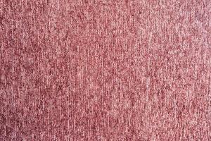 textura de pelusa de tela de alfombra roja rosa foto