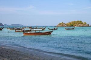 Long-tail wooden boats anchored on tropical sea in andaman photo