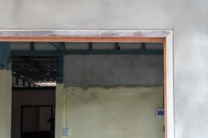 The door frame in the construction of a wooden house and cement. photo