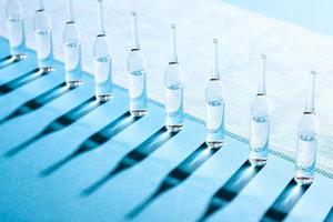 Ampules standing in a row along the bandage line. photo