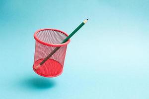 Flying red mesh pencil cup with a single pencil. photo