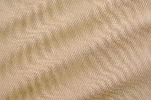 close-up Texture and Wavy of light brown canvas fabric as background photo