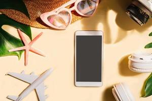 Travel summer accessories and empty screen smart phone on color background with copy space, Vacation planning concept photo