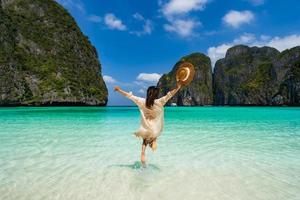 joven viajera relajándose y disfrutando en la hermosa playa tropical de arena blanca en maya bay en krabi, tailandia, vacaciones de verano y concepto de viaje