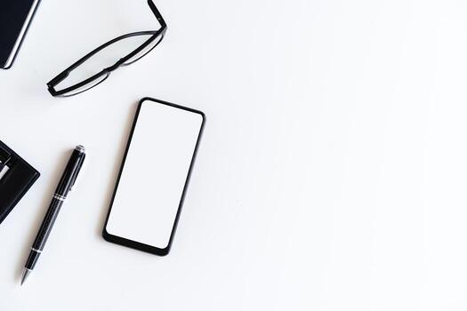 Empty screen Smart phone and file folder on business desk office with copy space photo