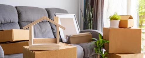 Stack of cardboard boxes in living room at new house on moving day photo