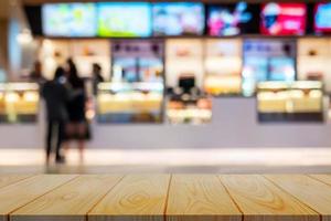 Empty wooden table background of free space for your with defocused food bar movie theater for your product display photo