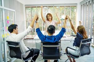 Happy Successful Business Group at office,Business team celebrating a triumph with arms up, achievement working in office concept photo