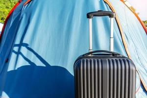 Travel suitcases in camping tent on countryside landscape background - Alternative summer holiday at national park - Road trip and freedom concept photo
