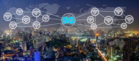 Communication network concept 5G and internet of things with smart city on night background. Modern city with wireless network connection concept, 5G network interface and wifi icon concept photo