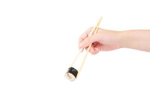 Female hand holding Unagi maki simple roll with wooden chopsticks isolated on white background photo