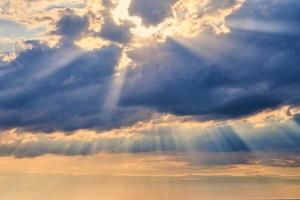 Sun rays and clouds, sunbeams shining through cumulus clouds, stunning scene of natural phenomenon photo