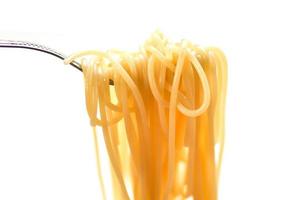 Spaghetti italian pasta in the restaurant italian food and menu concept - spaghetti on fork and white background photo