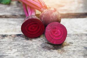 organic beetroot vegetable - fresh red beet roots harvested on wooden background photo