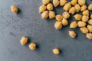 Natural food ingredients and healthy eating concept. Dry raw chickpeas on dark background. Protein food. Healthy nutrition concept photo