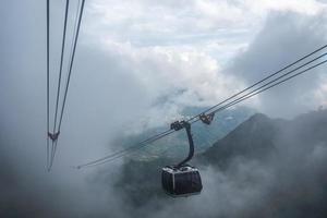 White cable car sightseeing Sapa village in valley on fog photo