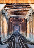 Train running on ancient railway on Long Bien bridge in Hanoi photo