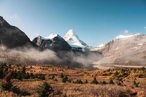 Scenery of mount Assiniboine with lake Magog and blue sky in autumn forest on provincial park at British Columbia photo