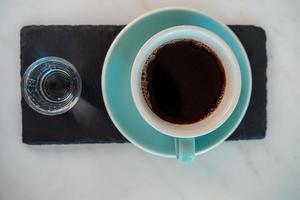 Cup of hot cappuccino coffee on table photo