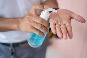 Men wash their hands with gel, alcohol or soap to kill bacteria after using public toilets. Prevents the spread of germs and bacteria and avoids corona virus infection. photo